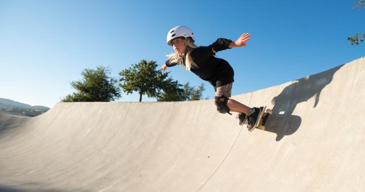 girl skateboarding in a skatepark